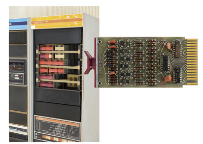 A flip chips from the internal card rack.  The flip chips for the early models were a kind of hybrid integrated circuits (ICs) baked the circuit elements on the cards. The PDP-8/I is a later model: this flip chip took the form of a common circuit board with logic ICs as the standard logic ICs were available at the production time.